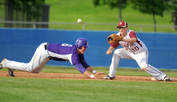 Hampden High School's Matt Martin (left) dives back to second base beating the pick-off attempt thrown to Bangor High School's Carl Farnham during the quarterfinal game in Bangor Thursday. Hampden High School's Matt Martin (left) dives back to second base beating the pick-off attempt thrown to Bangor High School's Carl Farnham during the quarterfinal game in Bangor Thursday.