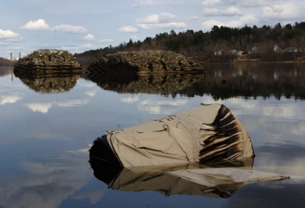 A large roll of partially burned paper came to a rest a few hundred yards downriver from the Maine Central Railroad rail car derailment along the Penobscot River in April 2006. A large roll of partially burned paper came to a rest a few hundred yards downriver from the Maine Central Railroad rail car derailment along the Penobscot River in April 2006.