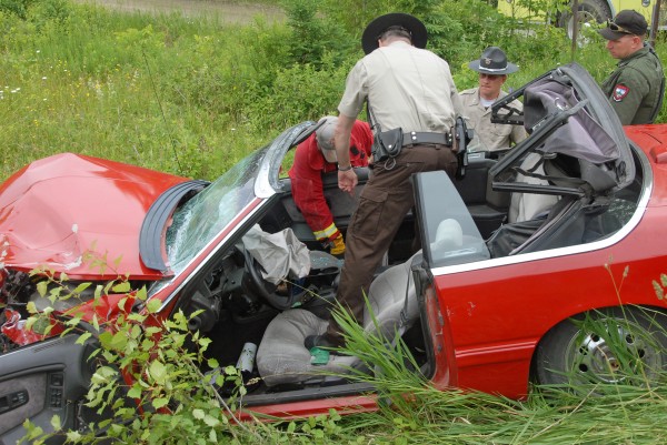 Lee Fire Chief Jay Crocker (from left), Penobscot County Sheriff's Department Deputy Peter Stone and Sgt. William Birch hunt through a Chrysler LeBaron convertible destroyed in a two-vehicle collision on Route 6 in Lee on Saturday, June 23, 2012. Four females were hurt in the crash. Lee Fire Chief Jay Crocker (from left), Penobscot County Sheriff's Department Deputy Peter Stone and Sgt. William Birch hunt through a Chrysler LeBaron convertible destroyed in a two-vehicle collision on Route 6 in Lee on Saturday, June 23, 2012. Four females were hurt in the crash.