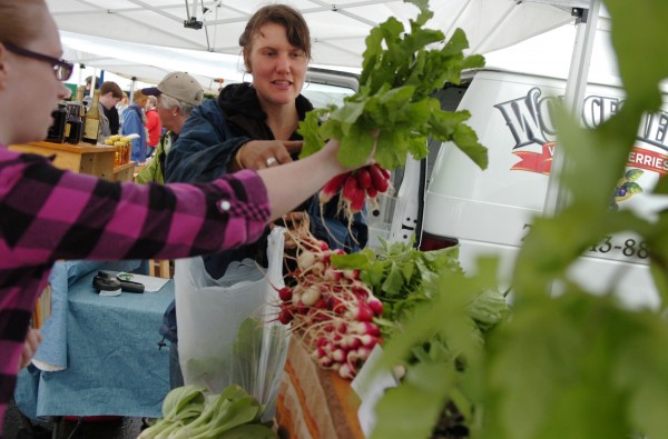 Molly Crouse of Nettie Fox Farm in Newburgh helps Samantha Fox of Winterport with the selection of radishes and Swiss chard during the Bangor farmers' market which made its debut Sunday afternoon, June 3, 2012. Molly Crouse of Nettie Fox Farm in Newburgh helps Samantha Fox of Winterport with the selection of radishes and Swiss chard during the Bangor farmers' market which made its debut Sunday afternoon, June 3, 2012.