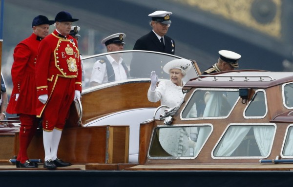 Britain's Queen Elizabeth II waves as she travels on a launch boat to be taken to the royal barge, the principal boat of a flotilla of 1,000 vessels on the River Thames, during a river pageant to celebrate the queen's Diamond Jubilee in London, Sunday, June 3, 2012. An armada of vessels, from historic sailboats and barges to kayaks, lifeboats and military launches, took part in Sunday's river pageant to mark the queen's 60 years on the throne. Britain's Queen Elizabeth II waves as she travels on a launch boat to be taken to the royal barge, the principal boat of a flotilla of 1,000 vessels on the River Thames, during a river pageant to celebrate the queen's Diamond Jubilee in London, Sunday, June 3, 2012. An armada of vessels, from historic sailboats and barges to kayaks, lifeboats and military launches, took part in Sunday's river pageant to mark the queen's 60 years on the throne.
