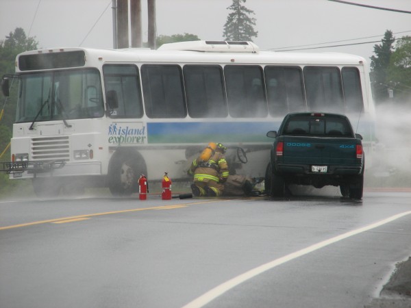 Firefighters examine a propane fuel tank on a Downeast Transportation bus that was struck by a pickup truck Wednesday, June 13, 2012, on Route 3 in Trenton. Concerns about gas leaking from the tank resulted in the road being closed and hundreds of motorists stranded for several hours. The vehicles eventually were moved and the road reopened after firefighters let all the gas leak out of the tank. Firefighters examine a propane fuel tank on a Downeast Transportation bus that was struck by a pickup truck Wednesday, June 13, 2012, on Route 3 in Trenton. Concerns about gas leaking from the tank resulted in the road being closed and hundreds of motorists stranded for several hours. The vehicles eventually were moved and the road reopened after firefighters let all the gas leak out of the tank.
