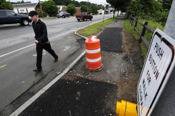 A pedestrian passes one of the new crosswalk signal posts that are on either side of Main Street near the entrance to Shaw's (seen on the other side of Main Street ) in Bangor Tuesday evening, June 26, 2012. Bangor's public works department has built a new pedestrian crossing at the intersection of Main and Patten streets across Main. A pedestrian passes one of the new crosswalk signal posts that are on either side of Main Street near the entrance to Shaw's (seen on the other side of Main Street ) in Bangor Tuesday evening, June 26, 2012. Bangor's public works department has built a new pedestrian crossing at the intersection of Main and Patten streets across Main.