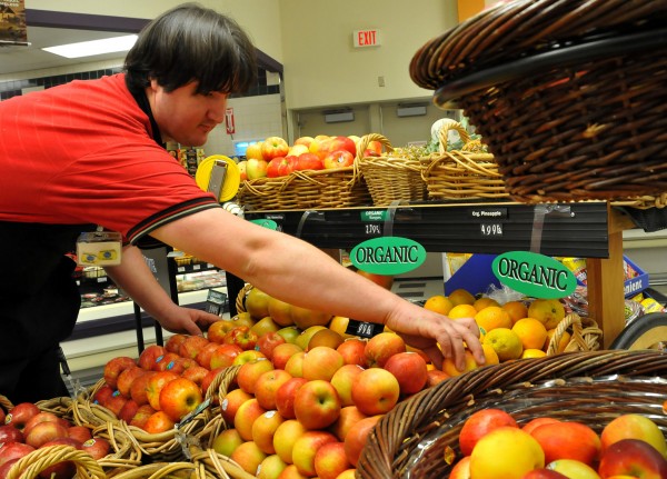 Take the time to spot the USDA "certified organic" sticker the next time you buy produce. People with the highest levels pesticides in their bloodstream are more likely to have sluggish metabolisms, report Canadian researchers. Here, produce clerk Josh Reeves organizes a cart of organic fruit at Kroger in Arlington, Texas, on Nov. 11, 2008. Take the time to spot the USDA "certified organic" sticker the next time you buy produce. People with the highest levels pesticides in their bloodstream are more likely to have sluggish metabolisms, report Canadian researchers. Here, produce clerk Josh Reeves organizes a cart of organic fruit at Kroger in Arlington, Texas, on Nov. 11, 2008.