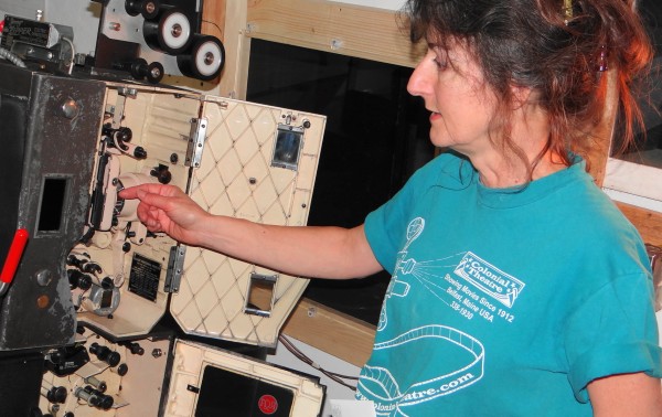 Therese Bagnardi, co-owner of the Colonial Theatre in Belfast, points to the insides of one of the 35-millimeter film projectors being replaced by digital equipment. Therese Bagnardi, co-owner of the Colonial Theatre in Belfast, points to the insides of one of the 35-millimeter film projectors being replaced by digital equipment.