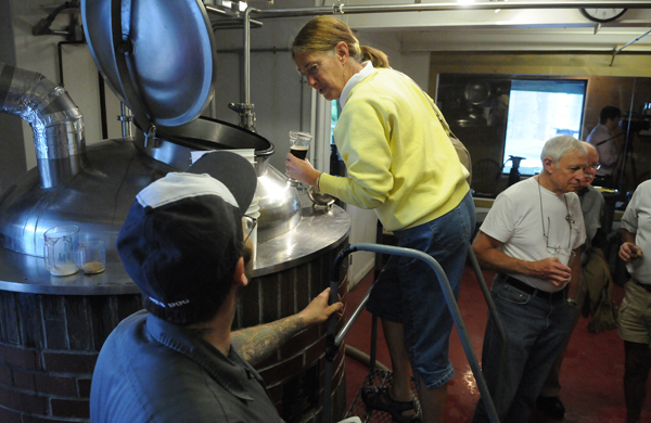 Linda Blicker of Hancock, New Hampshire peers into the brew pot at the Sea Dog Brewing Company in Bangor on Wednesday, June 27, 2012 while sipping a Sea Dog draft and listening to brew master Brooks Mathews (left) during a tour at the grand opening of the new barrel room. Linda Blicker of Hancock, New Hampshire peers into the brew pot at the Sea Dog Brewing Company in Bangor on Wednesday, June 27, 2012 while sipping a Sea Dog draft and listening to brew master Brooks Mathews (left) during a tour at the grand opening of the new barrel room.