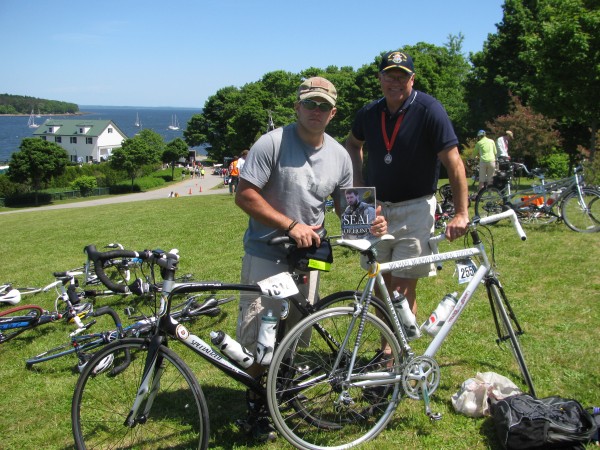 Trek Across Maine finishers Parker Christensen (left) of Brunswick and Terry Smith of Topsham pose with their bikes and a book which tells the story of Michael Murphy, their inspiration. Murphy was a Navy Seal who died in a firefight in Afghanistan in 2005. "I believe it was the spirit of Michael Murphy pushing me," Christensen said of his experience with the 180-mile bike journey. Trek Across Maine finishers Parker Christensen (left) of Brunswick and Terry Smith of Topsham pose with their bikes and a book which tells the story of Michael Murphy, their inspiration. Murphy was a Navy Seal who died in a firefight in Afghanistan in 2005. "I believe it was the spirit of Michael Murphy pushing me," Christensen said of his experience with the 180-mile bike journey.