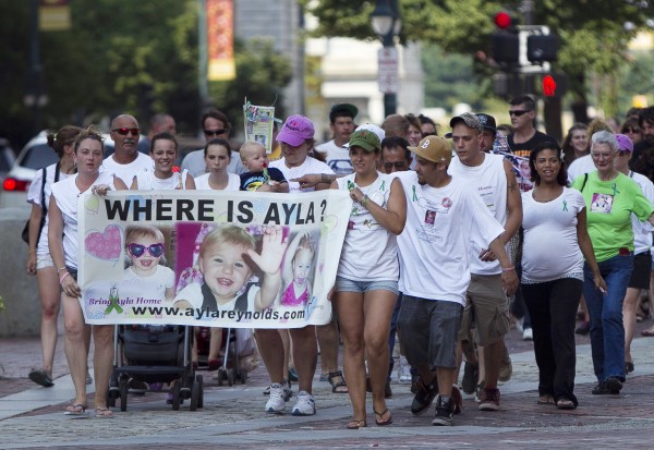 Trista Reynolds, mother of missing toddler Ayla Reynolds, holding banner at right, leads a walk in Portland Saturday to keep attention on her daughter's case until there's a resolution. Trista Reynolds, mother of missing toddler Ayla Reynolds, holding banner at right, leads a walk in Portland Saturday to keep attention on her daughter's case until there's a resolution.