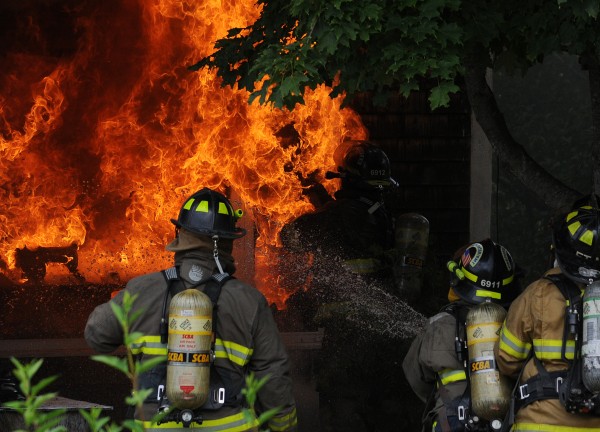 A firefighter is faced with a wall of flames as he breaks the glass on a residence at 289 West Etna Road in Etna on Monday, July 23, 2012. A firefighter is faced with a wall of flames as he breaks the glass on a residence at 289 West Etna Road in Etna on Monday, July 23, 2012.
