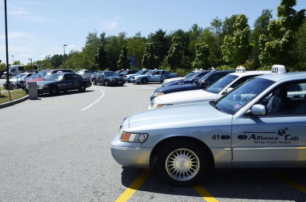 Taxis wait in a holding lot at the Portland International Jetport for their chance to queue outside the terminal. Renewed debate over the number taxis working the airport has spurred debate about whether the the city should limit the number of cabs across the city. Taxis wait in a holding lot at the Portland International Jetport for their chance to queue outside the terminal. Renewed debate over the number taxis working the airport has spurred debate about whether the the city should limit the number of cabs across the city.