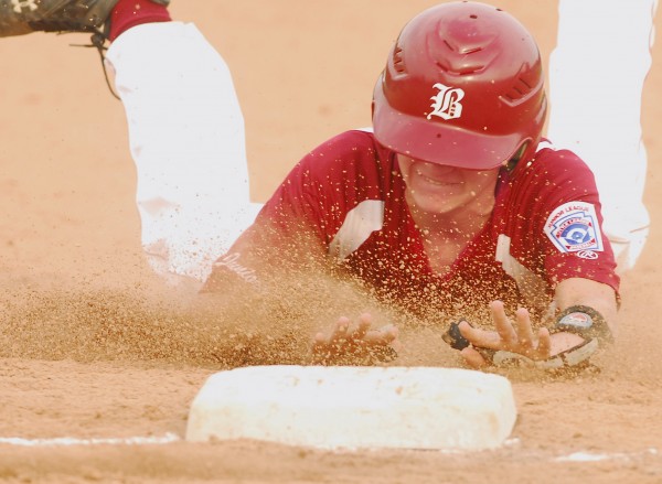 Bangor's Ethan Dorman slides safely into third base after tagging and advancing on a fly-ball out in the third inning of the first game of the District 3 Junior League all-star championship doubleheader Wednesday night at Mansfield Stadium. Bangor's Ethan Dorman slides safely into third base after tagging and advancing on a fly-ball out in the third inning of the first game of the District 3 Junior League all-star championship doubleheader Wednesday night at Mansfield Stadium.