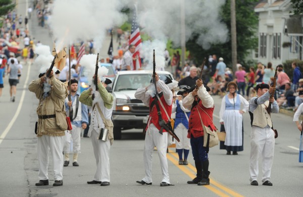Members of McCobb's Co., a Revolutionary War re-enactment group, fire muskets along Wilson Street in Brewer as part of the Bangor-Brewer Fourth of July parade on Wednesday. Members of McCobb's Co., a Revolutionary War re-enactment group, fire muskets along Wilson Street in Brewer as part of the Bangor-Brewer Fourth of July parade on Wednesday.
