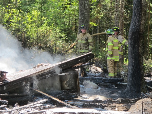 Firefighters from the Sedgwick Fire Department turn the hose on a Doe Circle workshop that was leveled by fire on Wednesday. Firefighters from the Sedgwick Fire Department turn the hose on a Doe Circle workshop that was leveled by fire on Wednesday.