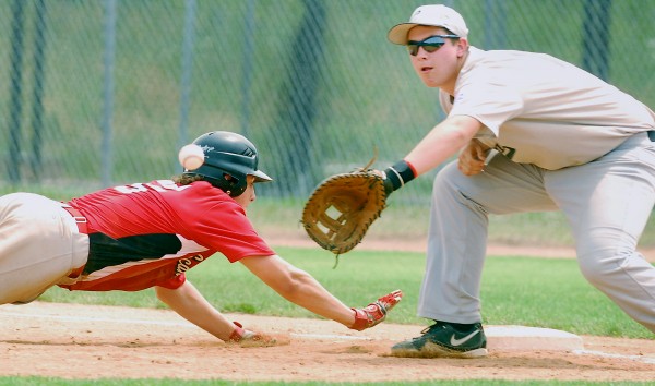 Scarborough's Zach Carriero (15) slides back to first ahead of the tag from Coastal's Cooper Smallidge (12) during first-inning action at Mansfield Stadium in Bangor on Saturday, July 28, 2012. Scarborough's Zach Carriero (15) slides back to first ahead of the tag from Coastal's Cooper Smallidge (12) during first-inning action at Mansfield Stadium in Bangor on Saturday, July 28, 2012.