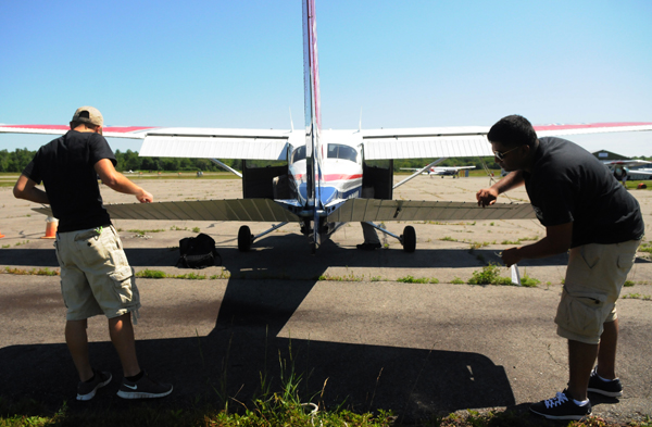 Kyle Hayes (left) of Pensacola Florida and Ameen Thonge (right) of New Jersey perform a preflight safety check on a Cessna as part of their Civil Air Patrol class in Old Town on Wednesday, July 11, 2012. Kyle Hayes (left) of Pensacola Florida and Ameen Thonge (right) of New Jersey perform a preflight safety check on a Cessna as part of their Civil Air Patrol class in Old Town on Wednesday, July 11, 2012.