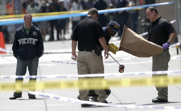 Officials collect evidence near the Empire State Building following a shooting, Friday, Aug. 24, 2012, in New York. Police say Jeffrey Johnson, 58, a recently laid-off worker, shot a former colleague to death near the iconic skyscraper and then randomly opened fire on people nearby before firing on police. New York City Mayor Michael Bloomberg said some of the victims may have been hit by police bullets as police and the gunman exchanged fire. Officials collect evidence near the Empire State Building following a shooting, Friday, Aug. 24, 2012, in New York. Police say Jeffrey Johnson, 58, a recently laid-off worker, shot a former colleague to death near the iconic skyscraper and then randomly opened fire on people nearby before firing on police. New York City Mayor Michael Bloomberg said some of the victims may have been hit by police bullets as police and the gunman exchanged fire.