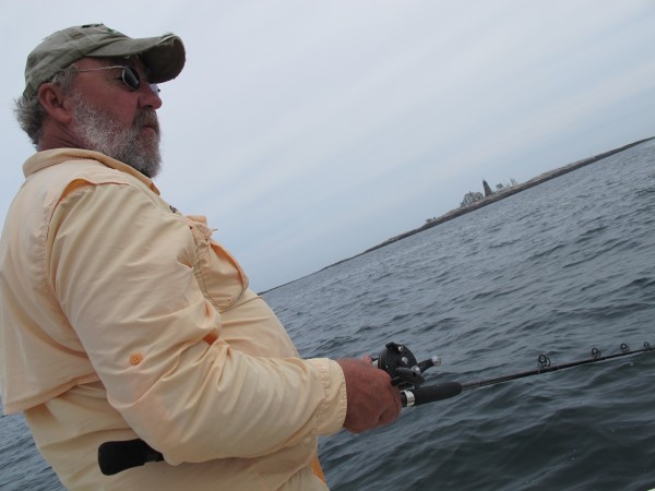 Pete Douvarjo of Eggemoggin Guide Service in Sedgwick fishes from his boat, "Reel Life," on Tuesday, July 31, 2012. In the background is Mount Desert Rock. Pete Douvarjo of Eggemoggin Guide Service in Sedgwick fishes from his boat, "Reel Life," on Tuesday, July 31, 2012. In the background is Mount Desert Rock.