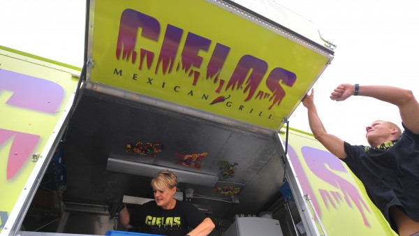 Kirsten Pilot (left) prepares food ingredients as her step-son Juergen Pilot opens up the serving window on the Cielos Mexican Grill food truck Thursday, Aug. 2, 2012. Kirsten Pilot came up with the idea for the new business and her husband and stepson were there to help out on the first day they opened for customers. The schedule for their serving locations can be found at www.cielostruck.com. Kirsten Pilot (left) prepares food ingredients as her step-son Juergen Pilot opens up the serving window on the Cielos Mexican Grill food truck Thursday, Aug. 2, 2012. Kirsten Pilot came up with the idea for the new business and her husband and stepson were there to help out on the first day they opened for customers. The schedule for their serving locations can be found at www.cielostruck.com.