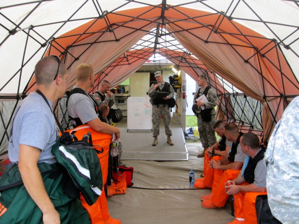 Maine Army National Guard Capt. Mike Gary briefs his team, dressed in Double A protective suits, during a drill Wednesday before their investigation of an explosion at the former Brunswick Naval Air Station. Maine Army National Guard Capt. Mike Gary briefs his team, dressed in Double A protective suits, during a drill Wednesday before their investigation of an explosion at the former Brunswick Naval Air Station.