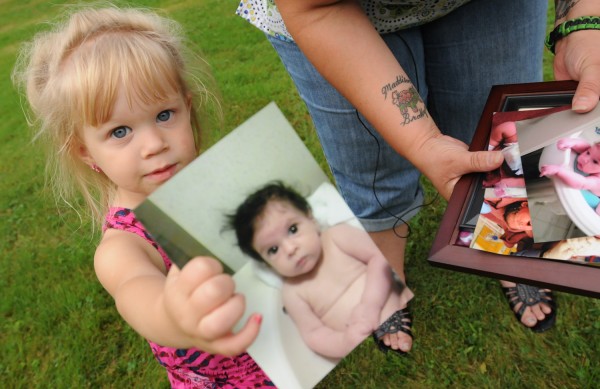 Maddison Foss-Greeenaway, 2, shows off a picture of her deceased sister Brooklyn as her mother talks to members of the media at her Clinton home on Friday, Aug. 31, 2012. Maddison Foss-Greeenaway, 2, shows off a picture of her deceased sister Brooklyn as her mother talks to members of the media at her Clinton home on Friday, Aug. 31, 2012.
