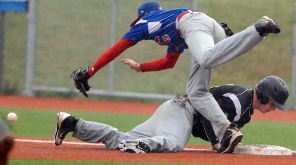 Canada's first baseman Laurent Dupuis-Solliec misses a throw from the pitcher in a pick-off attempt on U.S. East's Tyler Desjardins in the third inning of a Senior League World Series game on Thursday, Aug. 16, 2012, at Mahaney Diamond at the University of Maine in Orono. U.S. East won the game 3-2. Canada's first baseman Laurent Dupuis-Solliec misses a throw from the pitcher in a pick-off attempt on U.S. East's Tyler Desjardins in the third inning of a Senior League World Series game on Thursday, Aug. 16, 2012, at Mahaney Diamond at the University of Maine in Orono. U.S. East won the game 3-2.
