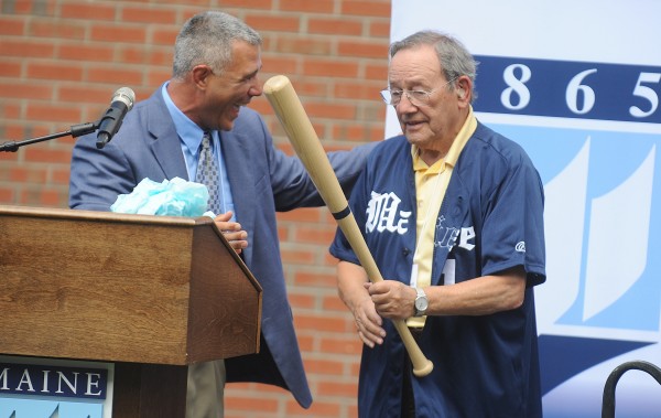 After presenting him with a team jersey, UMaine baseball head coach Steve Trimper presents UMaine trustee Paul Mitchell (right) with an honorary bat embossed with Mitchell's name during Tuesday's dedication ceremony for the new Paul Mitchell Batting Pavilion at the University of Maine in Orono. Coach Trimper was laughing because Mitchell had just asked him if he could get a replacement bat if he were to break it. After presenting him with a team jersey, UMaine baseball head coach Steve Trimper presents UMaine trustee Paul Mitchell (right) with an honorary bat embossed with Mitchell's name during Tuesday's dedication ceremony for the new Paul Mitchell Batting Pavilion at the University of Maine in Orono. Coach Trimper was laughing because Mitchell had just asked him if he could get a replacement bat if he were to break it.