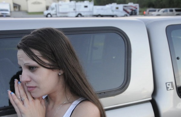 Shannon Lee anxiously waits outside the crime tape early Monday evening, Aug. 13, 2012 as police continued to work into the evening at the Target Industrial Park site where three bodies were found in a car which was set on fire early Monday. Lee said that the father of her seven-year-old daughter might be one of the persons who was found in the car. The mobile crime investigative vehicles can be seen in the background. Shannon Lee anxiously waits outside the crime tape early Monday evening, Aug. 13, 2012 as police continued to work into the evening at the Target Industrial Park site where three bodies were found in a car which was set on fire early Monday. Lee said that the father of her seven-year-old daughter might be one of the persons who was found in the car. The mobile crime investigative vehicles can be seen in the background.