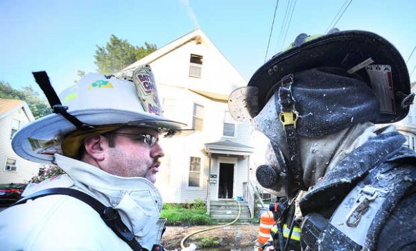 Battalion Chief Dean Milligan (left) of the Auburn Fire Department talks with firefighter Rob Dumont about the situation inside 116 Summer St. in Auburn just after exiting the third floor of the building. Battalion Chief Dean Milligan (left) of the Auburn Fire Department talks with firefighter Rob Dumont about the situation inside 116 Summer St. in Auburn just after exiting the third floor of the building.