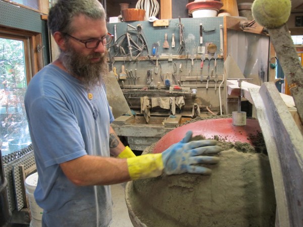 Rick Stevenson, a worker at Lunaform LLC, hand-packs concrete into a large bowl at the company's studio in Sullivan. Each piece requires several layers of concrete, applied over several days. Rick Stevenson, a worker at Lunaform LLC, hand-packs concrete into a large bowl at the company's studio in Sullivan. Each piece requires several layers of concrete, applied over several days.