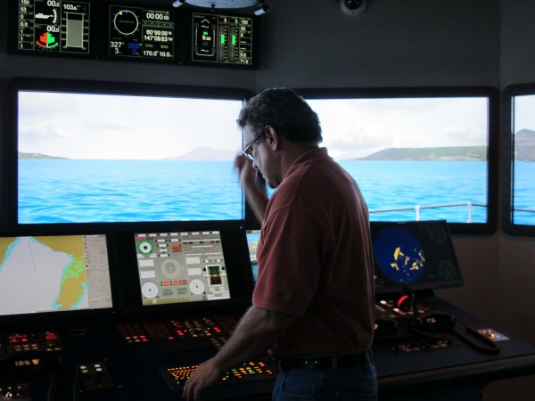 Jim Sanders, a simulation specialist at Maine Maritime Academy, takes the helm of the Bath Iron Works Bridge Simulator at the Castine school. Jim Sanders, a simulation specialist at Maine Maritime Academy, takes the helm of the Bath Iron Works Bridge Simulator at the Castine school.