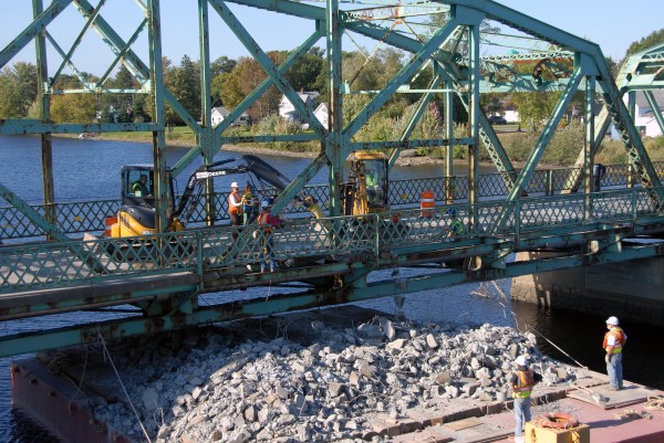 Howland's $10 million Piscataquis River bridge is finished, but Cianbro Corp. workers aren't: Now they have to take down the old bridge. They expect to finish that work in mid-December. Howland's $10 million Piscataquis River bridge is finished, but Cianbro Corp. workers aren't: Now they have to take down the old bridge. They expect to finish that work in mid-December.
