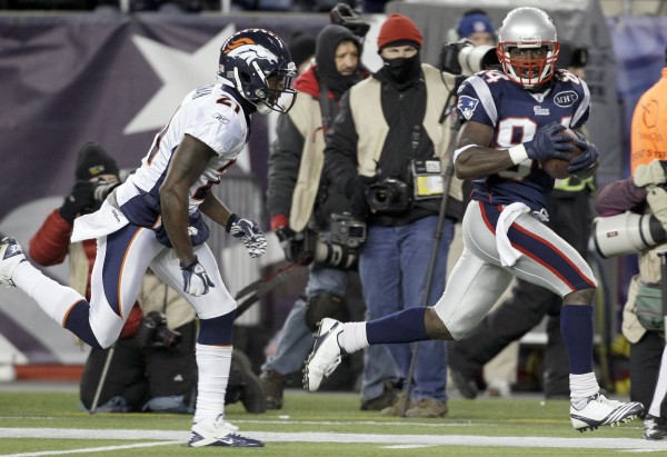 Denver Broncos cornerback Andre Goodman (21) tries to stop New England Patriots wide receiver Deion Branch (84) as he scores on a 61-yard touchdown during the first half of an NFL divisional playoff football game Jan. 14, 2012, in Foxborough, Mass. Denver Broncos cornerback Andre Goodman (21) tries to stop New England Patriots wide receiver Deion Branch (84) as he scores on a 61-yard touchdown during the first half of an NFL divisional playoff football game Jan. 14, 2012, in Foxborough, Mass.