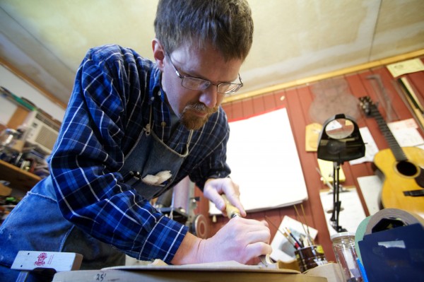 Carter Ruff, luthier and proprietor of Subterranean Music Works in Bath, carves a guitar brace Monday, Sept. 24, 2012. Ruff is making a guitar from a surviving pew from his church that burned down last year. Carter Ruff, luthier and proprietor of Subterranean Music Works in Bath, carves a guitar brace Monday, Sept. 24, 2012. Ruff is making a guitar from a surviving pew from his church that burned down last year.