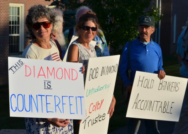Several Occupy Augusta protesters hold signs during a demonstration outside the Diamond Building at Colby College in Waterville on Wednesday, Sept. 12, 2012. Several Occupy Augusta protesters hold signs during a demonstration outside the Diamond Building at Colby College in Waterville on Wednesday, Sept. 12, 2012.