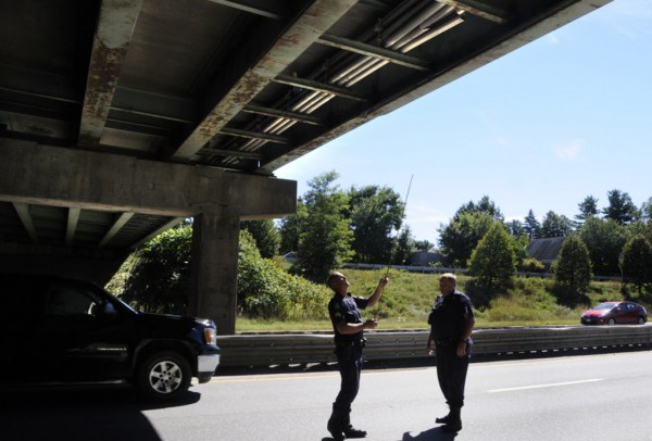 Maine State Police Sgt. Jason Sattler (left) and Trooper Phil Pushard use a tape measure to assess the structural damage to the Union Street bridge overpass after a truck's forklift and steel beam frame payload heading I-95-southbound failed to completely clear the overpass around 11:30 a.m. Thursday, Sept. 20, 2012. Maine State Police Sgt. Jason Sattler (left) and Trooper Phil Pushard use a tape measure to assess the structural damage to the Union Street bridge overpass after a truck's forklift and steel beam frame payload heading I-95-southbound failed to completely clear the overpass around 11:30 a.m. Thursday, Sept. 20, 2012.