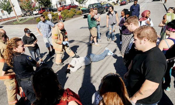 A Lewiston firefighter approaches a man laying in the intersection of Howe and Pine Streets in Lewiston on Monday. A Lewiston firefighter approaches a man laying in the intersection of Howe and Pine Streets in Lewiston on Monday.