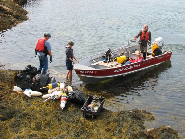 Pat Welch and Emma Pope-Welch prepare to load collected trash onto a Maine Island Trail Association boat while Henri Gignoux maneuvers the boat into position off Placentia Island on Saturday, Sept. 8, 2012. Pat Welch and Emma Pope-Welch prepare to load collected trash onto a Maine Island Trail Association boat while Henri Gignoux maneuvers the boat into position off Placentia Island on Saturday, Sept. 8, 2012.