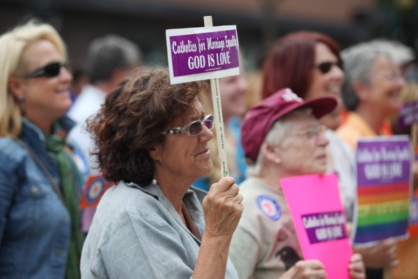 Cynthia Murray-Beliveau holds a sign as she listens to speakers Monday, Sept. 10, 2012 at a rally outside of City Hall in Portland in support of a ballot question that seeks to legalize same-sex marriage. Cynthia Murray-Beliveau holds a sign as she listens to speakers Monday, Sept. 10, 2012 at a rally outside of City Hall in Portland in support of a ballot question that seeks to legalize same-sex marriage.
