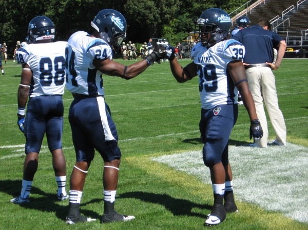 University of Maine teammates Khari Al-Mateen (left) and Rickey Stevens share a fist bump while warming up for Saturday's game against Bryant University in Smithfield, R.I. Al-Mateen returned an interception 77 yards for a touchdown and Stevens rushed for 168 yards in the Black Bears' 51-7 victory. University of Maine teammates Khari Al-Mateen (left) and Rickey Stevens share a fist bump while warming up for Saturday's game against Bryant University in Smithfield, R.I. Al-Mateen returned an interception 77 yards for a touchdown and Stevens rushed for 168 yards in the Black Bears' 51-7 victory.