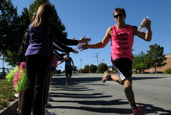 John Bapst cheerleaders line Main Street in Bangor to cheer on and high five runners in the 16th annual Susan G. Komen Race for the Cure road race on Sunday, Sept. 16, 2012. John Bapst cheerleaders line Main Street in Bangor to cheer on and high five runners in the 16th annual Susan G. Komen Race for the Cure road race on Sunday, Sept. 16, 2012.
