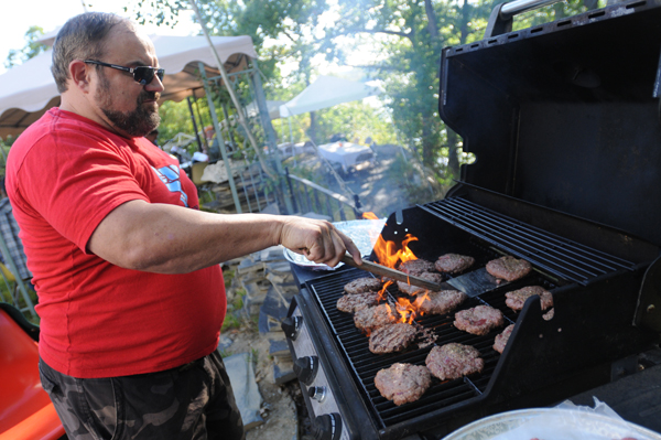 Randy Tompkins mans the grill while cooking organic burgers at the 10th annual Food AND Medicine Labor Day Celebration in Brewer on Monday, Sept. 3, 2012. Randy Tompkins mans the grill while cooking organic burgers at the 10th annual Food AND Medicine Labor Day Celebration in Brewer on Monday, Sept. 3, 2012.