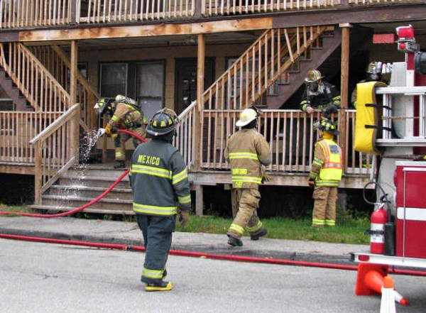 Rumford fire Chief Bob Chase (center) confers with a Mexico firefighter at an apartment building at 58 Falmouth St. on Wednesday morning. A hole in a chimney was discovered after blistering paint was observed on a hot wall. Rumford fire Chief Bob Chase (center) confers with a Mexico firefighter at an apartment building at 58 Falmouth St. on Wednesday morning. A hole in a chimney was discovered after blistering paint was observed on a hot wall.