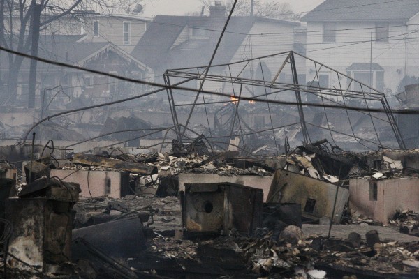 Homes damaged by a fire at Breezy Point, in the New York City borough of Queens, smolder Tuesday, Oct. 30, 2012. Homes damaged by a fire at Breezy Point, in the New York City borough of Queens, smolder Tuesday, Oct. 30, 2012.