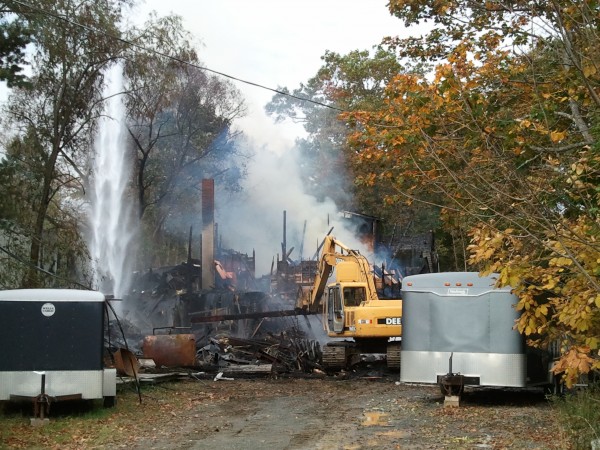 A backhoe pulls apart burning rubble Tuesday morning at the R.L. White & Son contracting business in the Bar Harbor village of Hulls Cove. The fire was reported around 3 a.m. Tuesday. There are no reported injuries and no word yet on what started the blaze. A backhoe pulls apart burning rubble Tuesday morning at the R.L. White & Son contracting business in the Bar Harbor village of Hulls Cove. The fire was reported around 3 a.m. Tuesday. There are no reported injuries and no word yet on what started the blaze.
