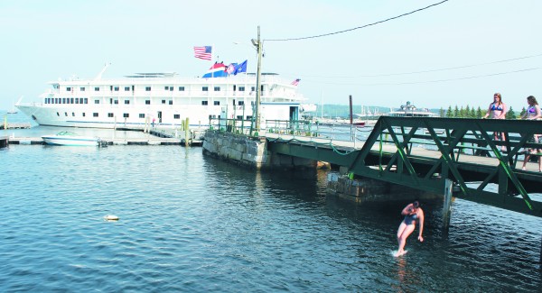 Shaydlyn Robinson, 14, of Owls Head, jumps off the Rockland Public Landing at high tide in June 2011, as her friends look on. Shaydlyn Robinson, 14, of Owls Head, jumps off the Rockland Public Landing at high tide in June 2011, as her friends look on.