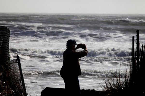 A man takes pictures with his phone at Higgins Beach in Scarborough on Tuesday, Oct. 30, 2012, the day after Hurricane Sandy. A man takes pictures with his phone at Higgins Beach in Scarborough on Tuesday, Oct. 30, 2012, the day after Hurricane Sandy.