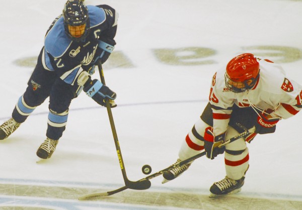 Maine's Mike Cornell (2) battles with St. Lawrence's Jeremy Wick for control of the puck during first-period action at Alfond Arena in Orono, Friday night, Oct. 19, 2012. Maine's Mike Cornell (2) battles with St. Lawrence's Jeremy Wick for control of the puck during first-period action at Alfond Arena in Orono, Friday night, Oct. 19, 2012.