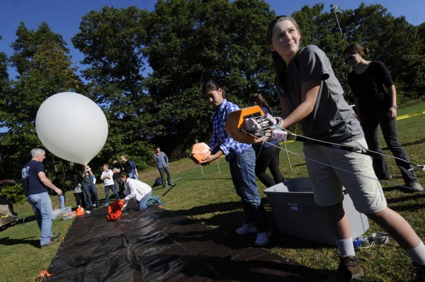 Bangor High School STEM program students Paige Brown (right) and Aidan Coyne (second from right) carefully hold the weather balloon's scientific payload as they help fellow scientists prepare the balloon for launch from Bangor High School's soccer field Thursday morning, Sept. 27, 2012.The STEM program science students launched the balloon with the help of Dr. Rick Eason of the University of Maine, his assistants and Bangor High School science teachers Ted Taylor and Cary James. The balloon is expected to loft 100,000 feet — to the edge of the atmosphere — at which point it is expected to burst and fall back to earth. The students and their teachers expect to retrieve the payload with sensors. Bangor High School STEM program students Paige Brown (right) and Aidan Coyne (second from right) carefully hold the weather balloon's scientific payload as they help fellow scientists prepare the balloon for launch from Bangor High School's soccer field Thursday morning, Sept. 27, 2012.The STEM program science students launched the balloon with the help of Dr. Rick Eason of the University of Maine, his assistants and Bangor High School science teachers Ted Taylor and Cary James. The balloon is expected to loft 100,000 feet — to the edge of the atmosphere — at which point it is expected to burst and fall back to earth. The students and their teachers expect to retrieve the payload with sensors.