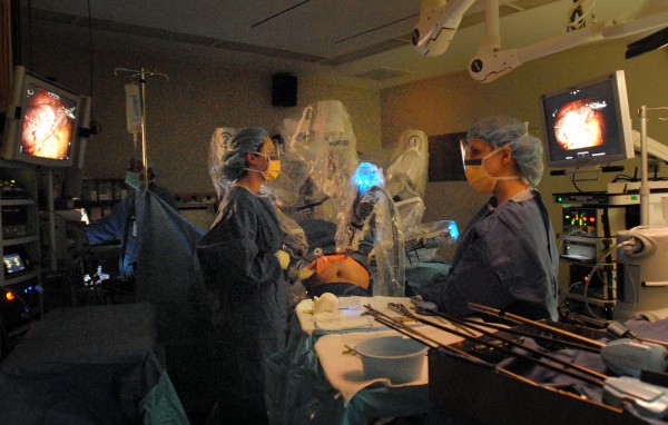 Physicians Assistant Rochelle Loeb (left) staples the area of the stomach under Dr. Toder's guide (who is unseen, operating the robotic arms) during a robotic sleeve gastrectomy procedure at EMMC on Thursday morning. Physicians Assistant Rochelle Loeb (left) staples the area of the stomach under Dr. Toder's guide (who is unseen, operating the robotic arms) during a robotic sleeve gastrectomy procedure at EMMC on Thursday morning.