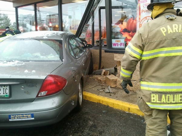 A firefighter examines the scene where a car collided with the entrance of a Dunkin' Donuts in Paris. A firefighter examines the scene where a car collided with the entrance of a Dunkin' Donuts in Paris.